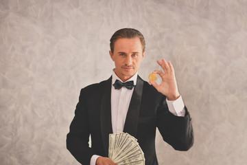 Concept Very wealthy businessman. Businessman is happy with his money.A businessman showing his money.