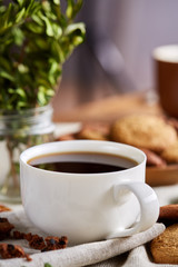 Breakfast background with mug of fresh coffee, homemade oatmeal cookies, grind coffee