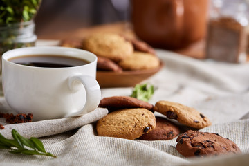 Breakfast background with mug of fresh coffee, homemade oatmeal cookies, grind coffee