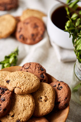 Breakfast background with mug of fresh coffee, homemade oatmeal cookies, grind coffee