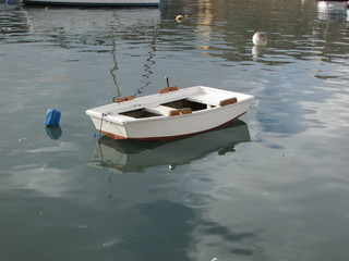 Little white traditional maltese fishermans boat
