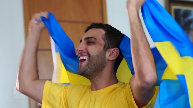 Swedish fan celebrating with flag