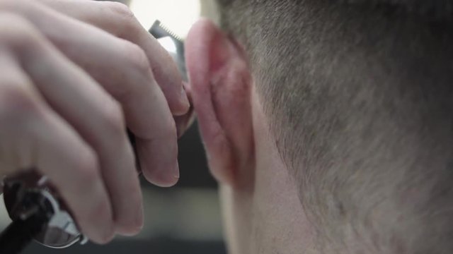 barber making haircut using machine