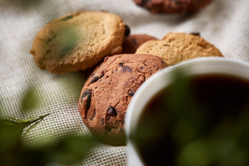 Breakfast background with mug of fresh coffee, homemade oatmeal cookies, grind coffee