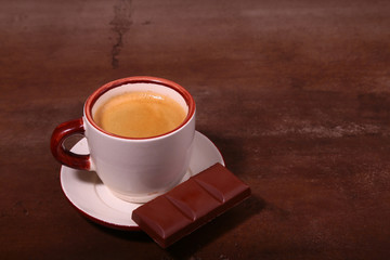 Coffee cup and chocolate on wooden table texture. Coffeebreak