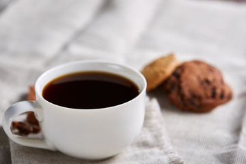 Breakfast background with mug of fresh coffee, homemade oatmeal cookies, grind coffee