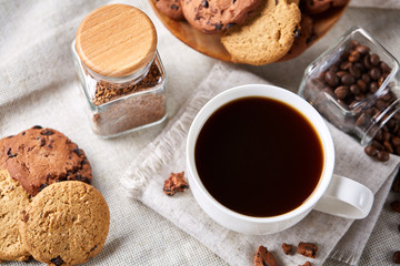 Breakfast background with mug of fresh coffee, homemade oatmeal cookies, grind coffee