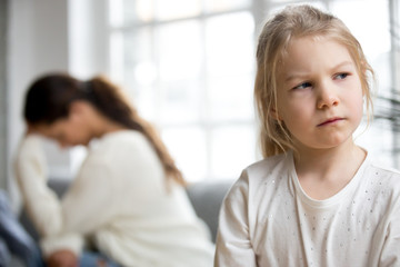 Sulky angry offended child girl pouting not talking to desperate mother tired of difficult kid,...