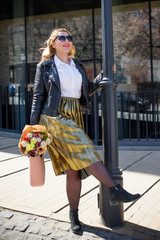 A woman of plus size, American or European appearance walks in the city enjoying life. A young lady...