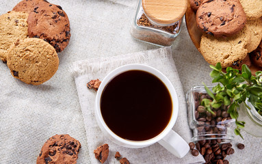 Breakfast background with mug of fresh coffee, homemade oatmeal cookies, grind coffee