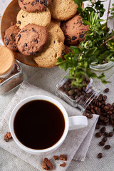 Breakfast background with mug of fresh coffee, homemade oatmeal cookies, grind coffee