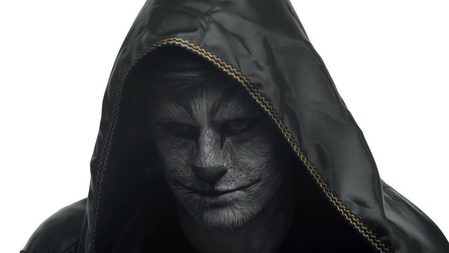Close-up, Handsome Guy in the Black Hood with the Beast Grim Pensively Looks Before Himself