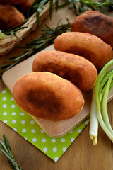 Golden fried patties on a wooden board surrounded green onion and tarragon. Russian cuisine meal
