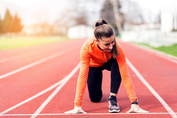 Fototapeta premium Athlete woman at starting line