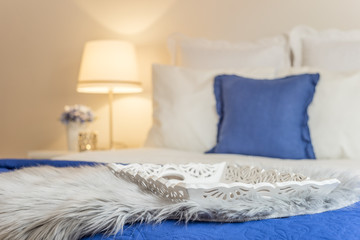 Carved wooden tray decorating elegant bedroom in white and blue