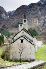 Fototapeta premium old rustic historic stone church in a remote mountian valley in the Swiss Alps