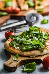 Pizza with fresh arugula and feta cheese