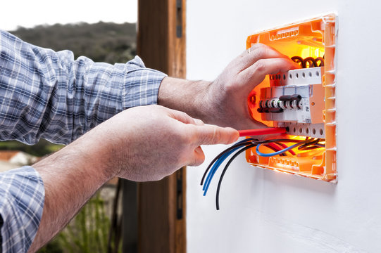 Electrician technician repairs the electrical panel of a residential system