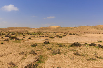 Far hills in desert under sky at winter