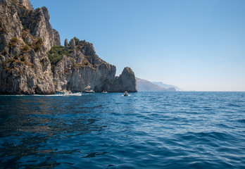 Fototapeta na wymiar Boats with tourists near Grotta Bianca and Grotta Meravigliosa, Capri, Italy