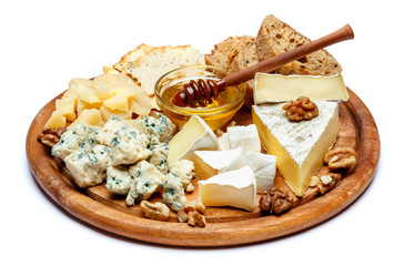 Brie cheese on a wooden Board with bread and sweet honey