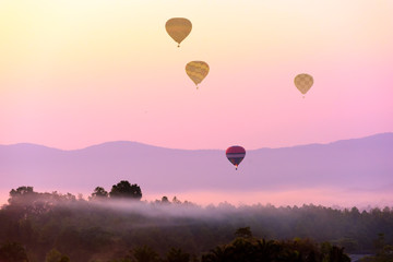 Colorful hot air balloon on sunrise .