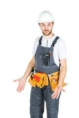 A builder or an employee in a protective helmet is surprised. Isolated over white background.