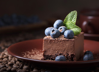 Chocolate cake with blueberries and mint .