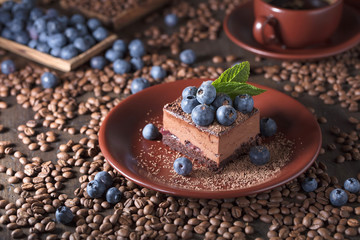 Fototapeta na wymiar Chocolate cake with blueberries and mint .
