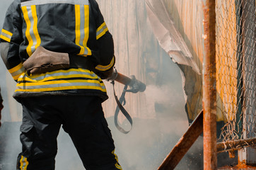 fireman extinguishes fire