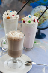 two milkshakes of vanilla, strawberry and coffee