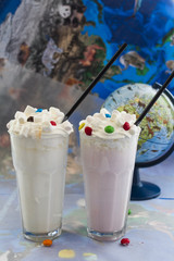two milkshakes of vanilla and strawberry close-up