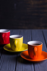 colored cups with coffee