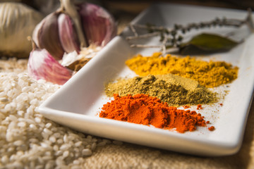Detail of a still life with part of the ingredients to make a race stew with vegetables and spices.