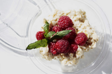 oatmeal with raspberries on white background