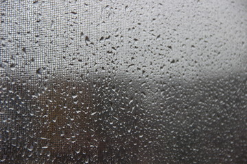 Background, texture – drops of rain water on the misted glass window cloudy autumn
