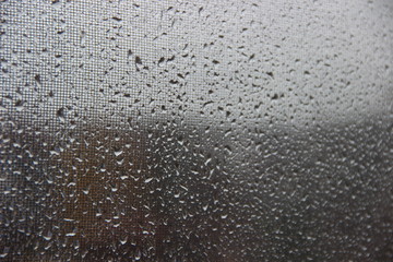 Background, texture – drops of rain water on the misted glass window cloudy autumn