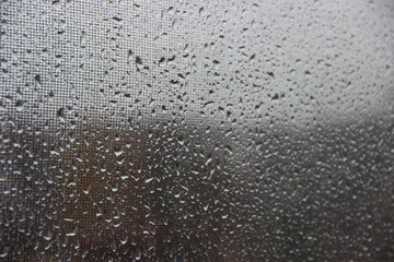 Background, texture – drops of rain water on the misted glass window cloudy autumn