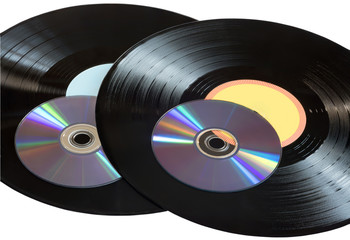 Vinyl records and CDs disks on a white background.
