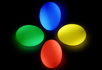 Coloured Easter bright eggs on the black isolated background.