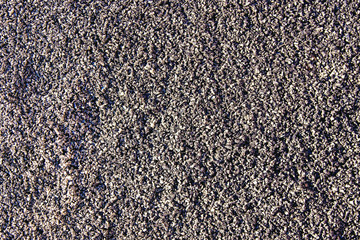small black shiny rubber crumb. texture, background