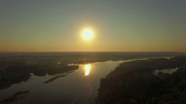 aerial view of river at sunrise 4K, forest and river in morning mist, Very high view of the river forest at sunrise, Aerial view of mystical river at sunrise with fog, sun above the river aerial