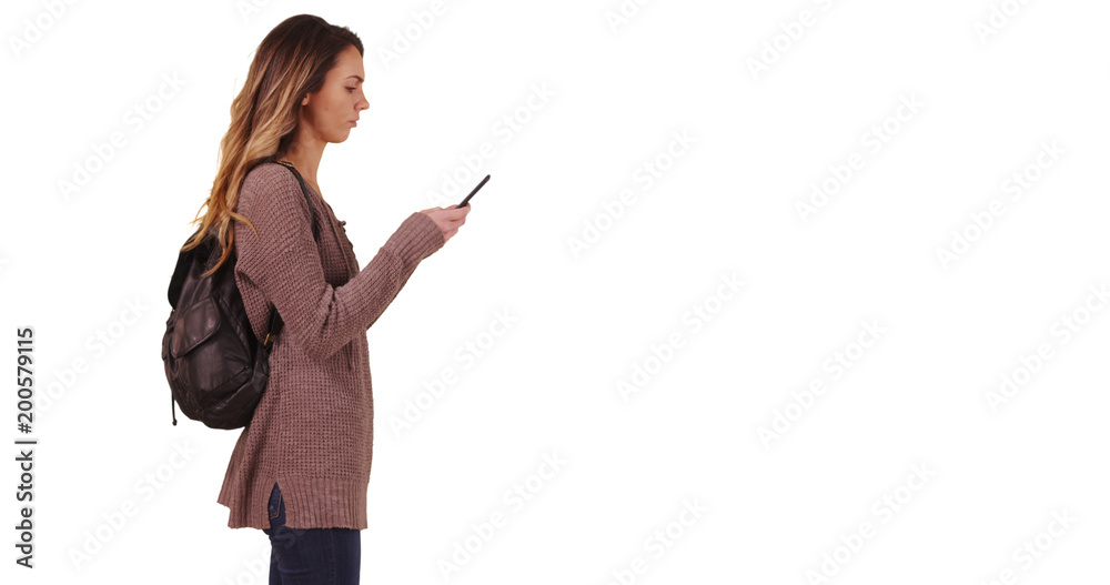 Wall mural Millennial answering text message on smartphone waiting for someone