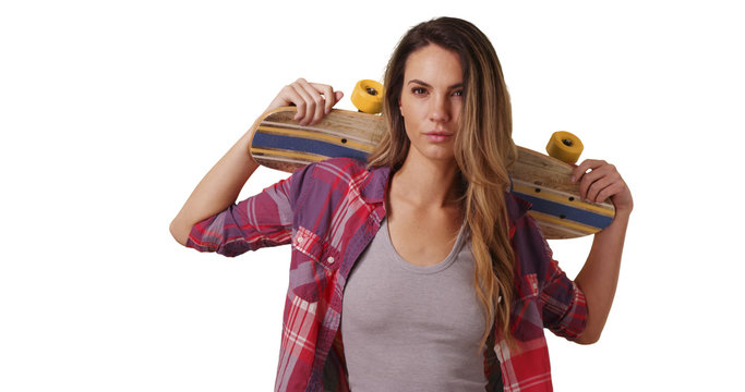 Millennial girl posing with skateboard on white background with copyspace