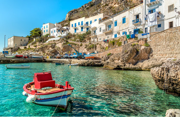 View of Levanzo Island with Fisherman boat in foreground, is the smallest of the three Aegadian islands in the Mediterranean sea of Sicily, Trapani, Italy - obrazy, fototapety, plakaty