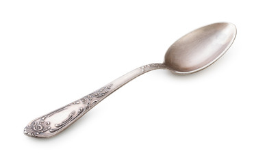 Vintage silverware, old decorated spoon isolated on a white, close up.