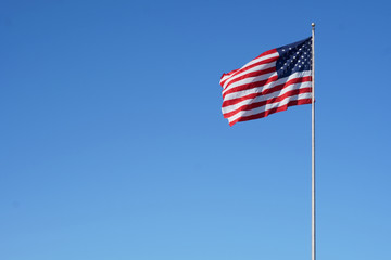 The American flag floats in the air proudly.                              