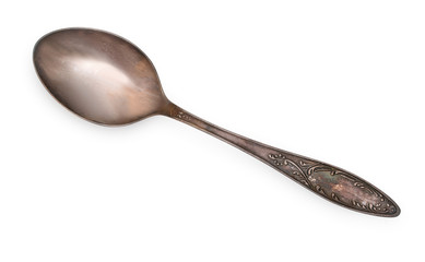 Vintage silverware, old decorated spoon isolated on a white, top view, close up.
