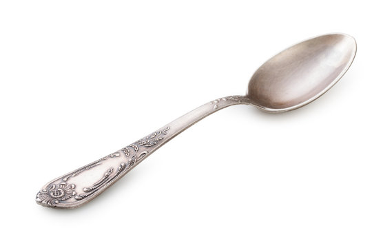 Vintage silverware, old decorated spoon isolated on a white, close up.