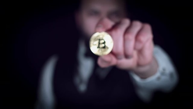 4K Businessman Holding Bitcoin at Camera
